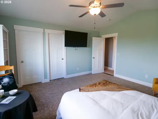 a bedroom with a bed and a chandelier