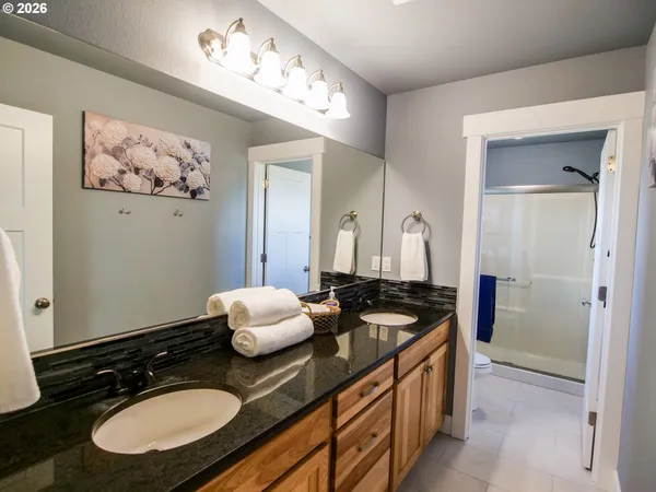 a bathroom with a sink double vanity and a mirror