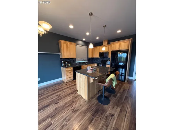 a kitchen with a sink appliances and furniture