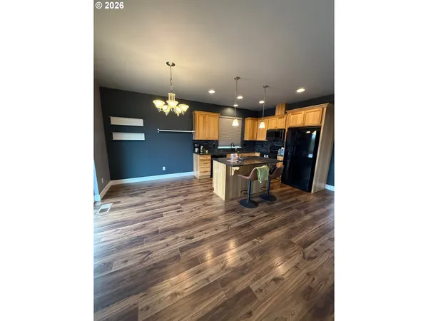 a view of a dining room with furniture and a chandelier