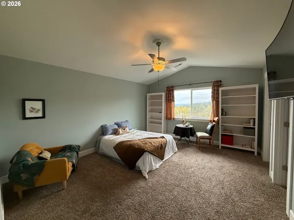 a spacious bedroom with a bed and a chandelier