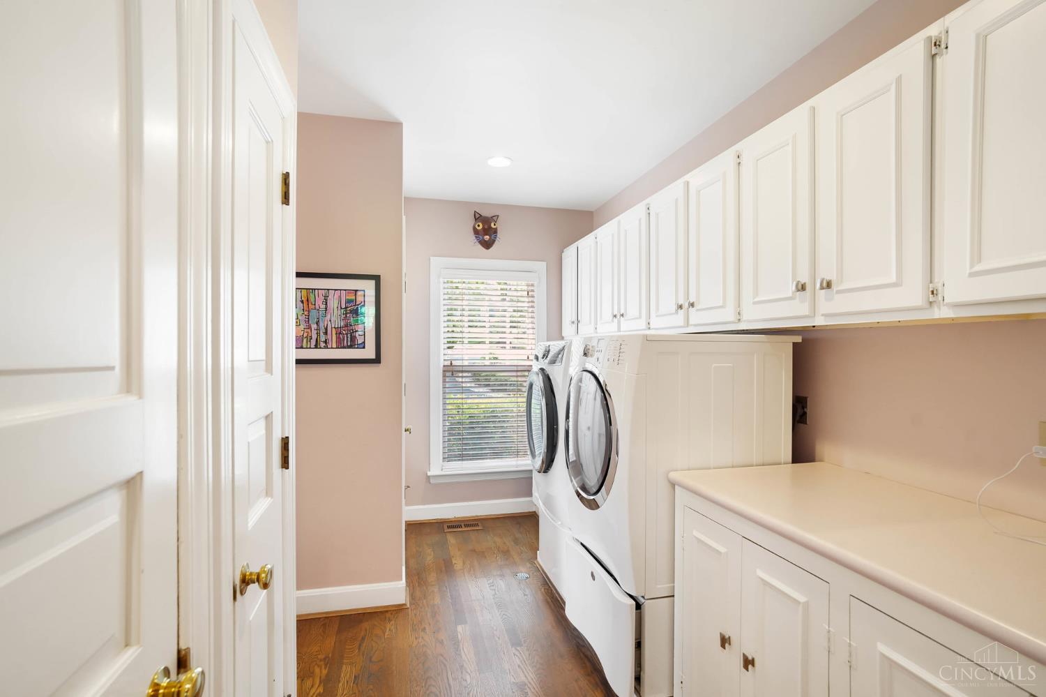 2780 Walsh Road Cincinnati, OH 45208 - Photo 15 of 68 The well-appointed laundry and mudroom is designed for everyday functionality—featuring abundant cabinetry, generous counter space and a utility sink for added convenience. The adjoining mudroom offers built-in storage and organization, creating a seamless transition from the outdoors while keeping daily essentials neatly tucked away.