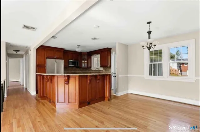 a view of a room with wooden floor and entryway
