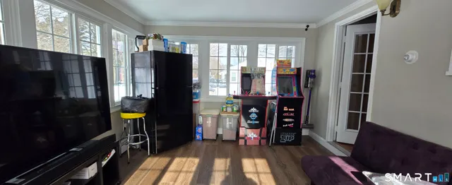 a view of a livingroom with furniture and a window