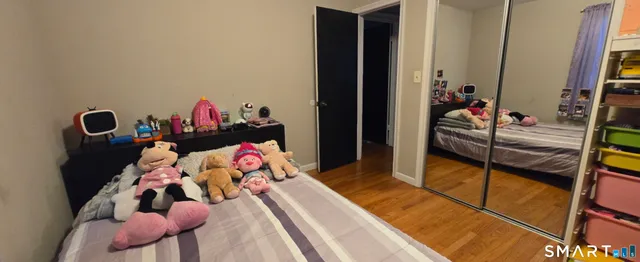 a bedroom with a bed and a flat tv screen