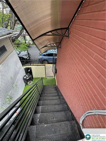 a view of a door and car parked in the yard