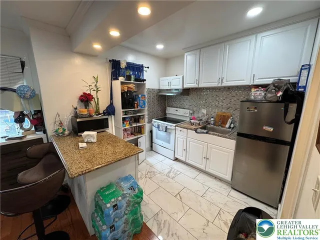 a living room with lots of furniture and clutter