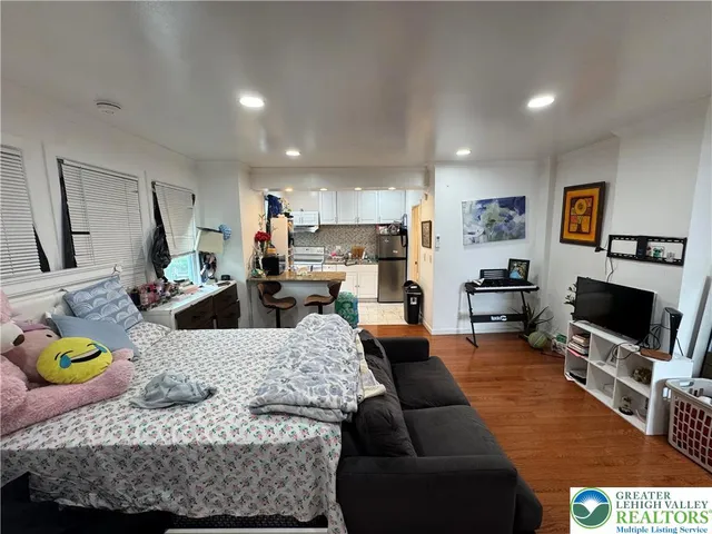 a bed room with a bed and a television