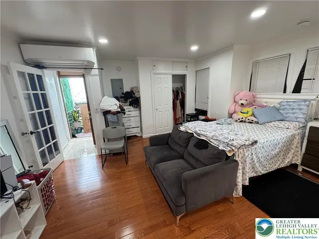 a bed room with furniture and wooden floor