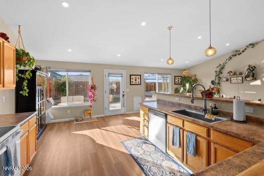 552 Spur Court Fernley, NV 89408 - Photo 21 of 46 a open kitchen with stainless steel appliances granite countertop a sink and a large window