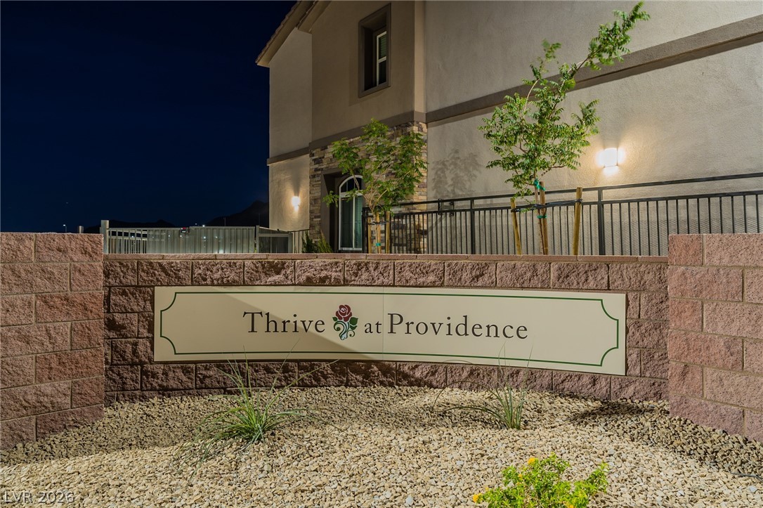6444 Spring Jog Street Las Vegas, NV 89166 - Photo 6 of 13 This inviting entrance features a prominent sign, well-maintained landscaping, and elegant exterior lighting.