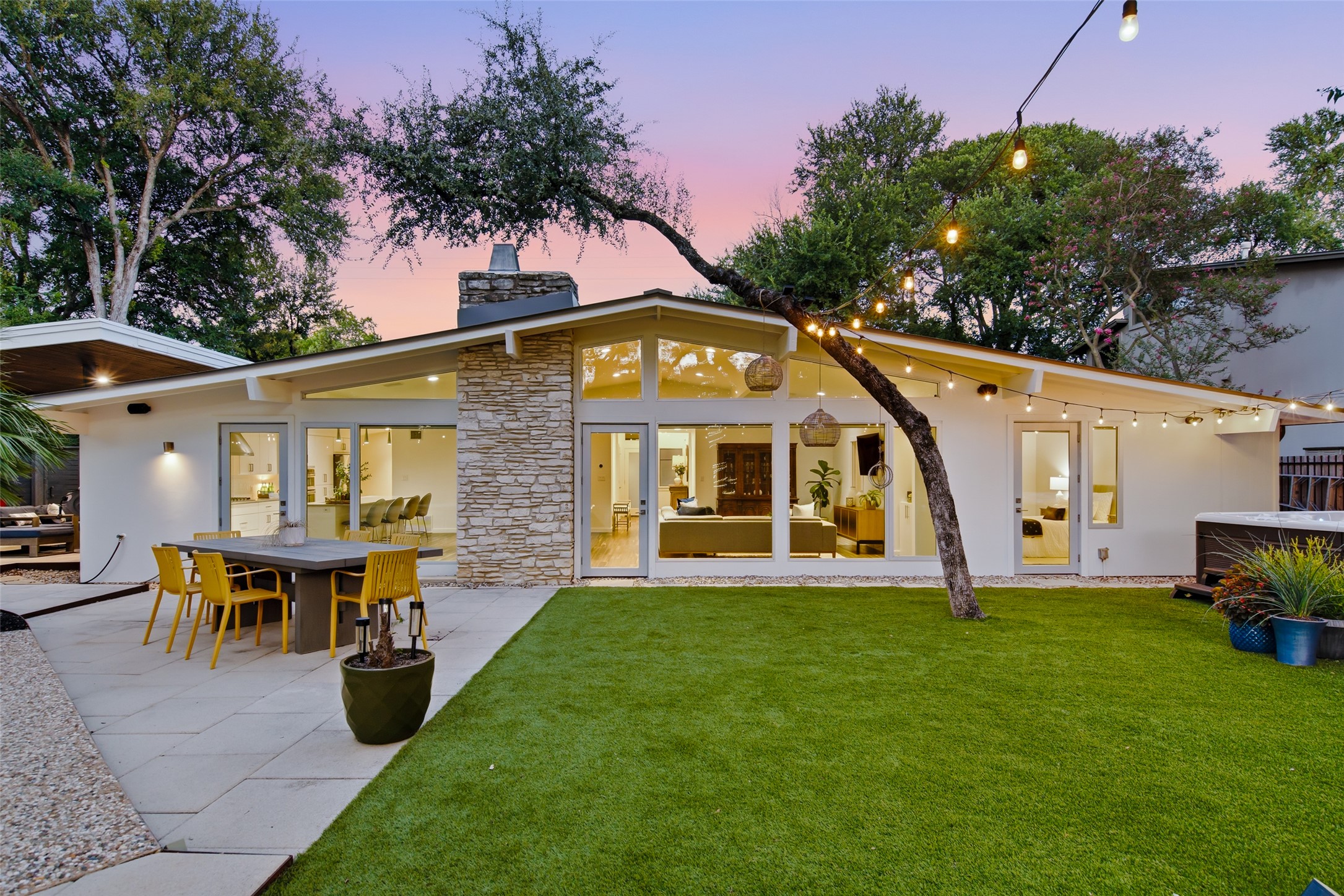 412 Ridgewood Road West Lake Hills, TX 78746 - Photo 36 of 40 An inviting backyard oasis offers a sprawling lawn, a paved patio for alfresco dining, and a tranquil spa.