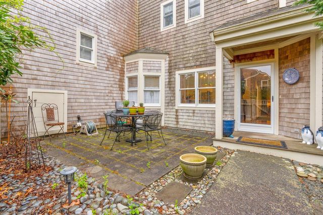 a view of a backyard with table and chairs and potted plants