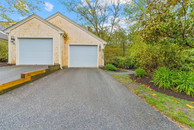 a view of a house with a yard and garage