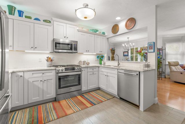 a kitchen with cabinets and stainless steel appliances