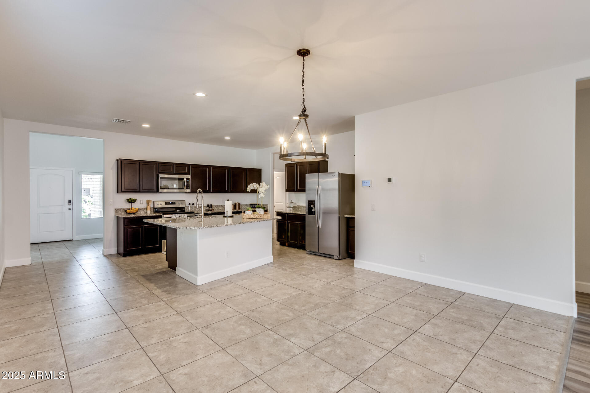 4750 East Chromium Road San Tan Valley, AZ 85143 - Photo 41 of 74 a large kitchen with stainless steel appliances granite countertop a stove top oven a sink dishwasher and a refrigerator with wooden floor