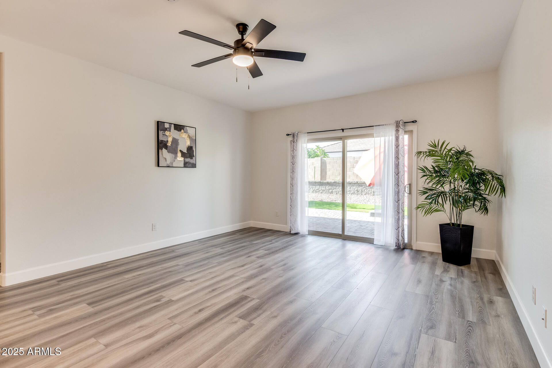4750 East Chromium Road San Tan Valley, AZ 85143 - Photo 47 of 74 a view of an empty room with wooden floor and a window