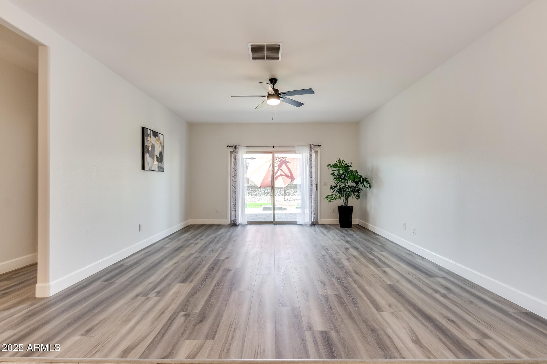 4750 East Chromium Road San Tan Valley, AZ 85143 - Photo 49 of 74 wooden floor in an empty room with a window