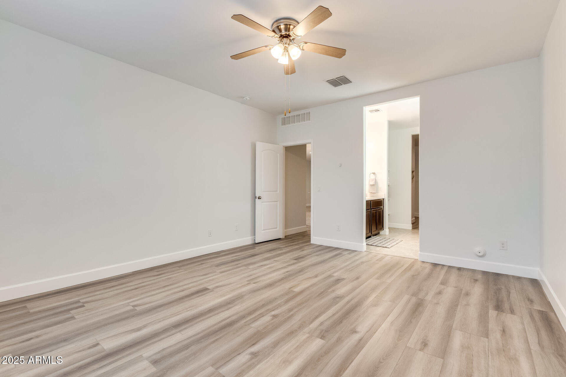 4750 East Chromium Road San Tan Valley, AZ 85143 - Photo 52 of 74 a view of an empty room with window and a ceiling fan