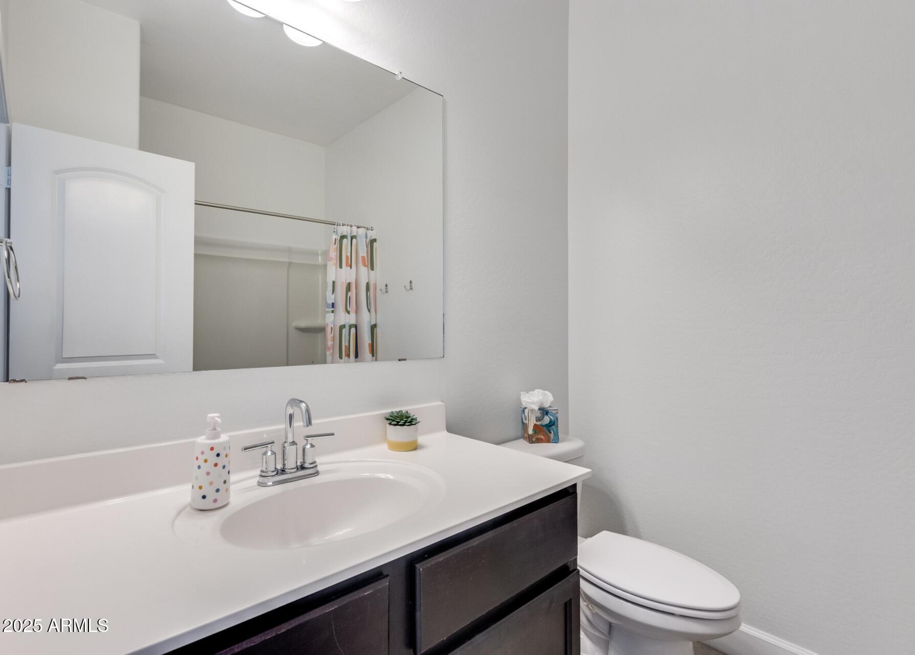 4750 East Chromium Road San Tan Valley, AZ 85143 - Photo 60 of 74 a bathroom with a sink a toilet and mirror