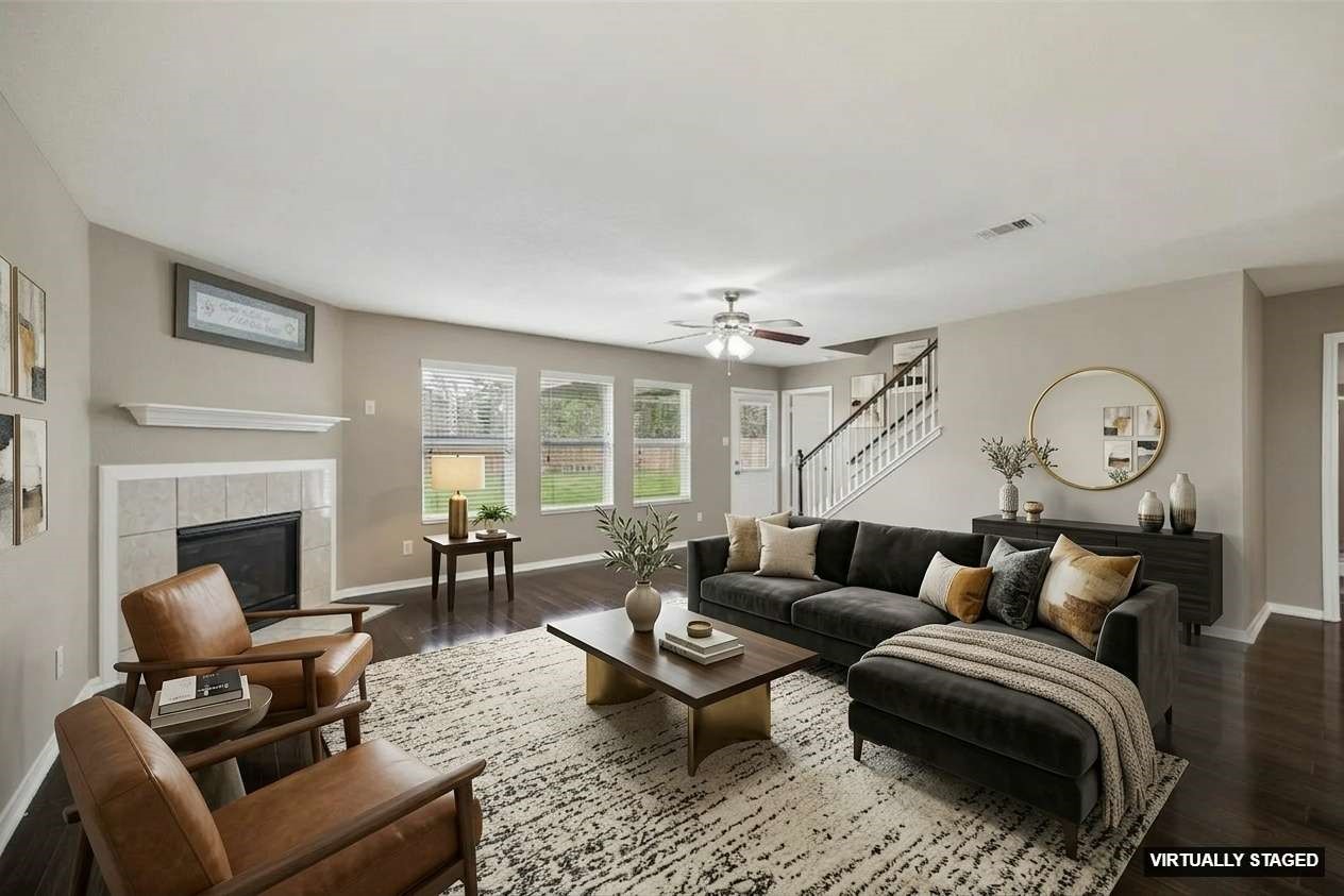 15642 South Fall Fern Circle Houston, TX 77044 - Photo 2 of 32 a living room with furniture a fireplace and a large window