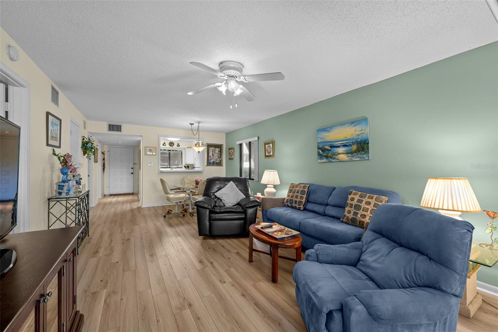 5290 Willow Links, Unit 57 Sarasota, FL 34235 - Photo 13 of 46 a living room with furniture and wooden floor
