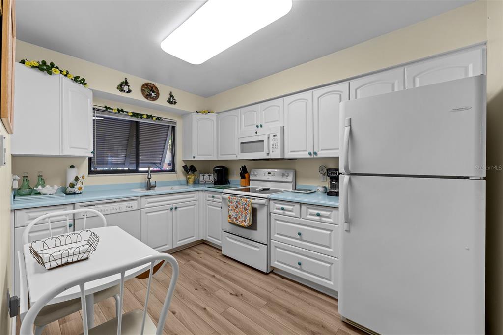 5290 Willow Links, Unit 57 Sarasota, FL 34235 - Photo 18 of 46 a kitchen with stainless steel appliances granite countertop a refrigerator and a stove top oven