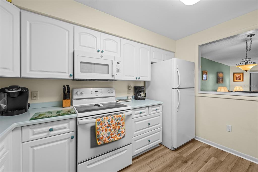 5290 Willow Links, Unit 57 Sarasota, FL 34235 - Photo 20 of 46 a kitchen with refrigerator a stove and cabinets