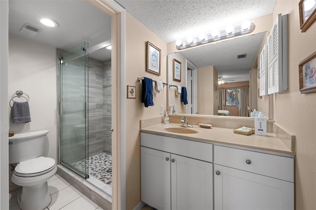 5290 Willow Links, Unit 57 Sarasota, FL 34235 - Photo 7 of 46 a bathroom with a toilet sink and shower