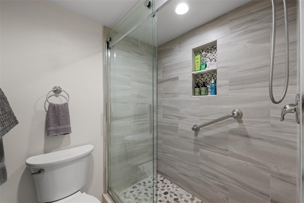 5290 Willow Links, Unit 57 Sarasota, FL 34235 - Photo 8 of 46 a bathroom with a shower and toilet