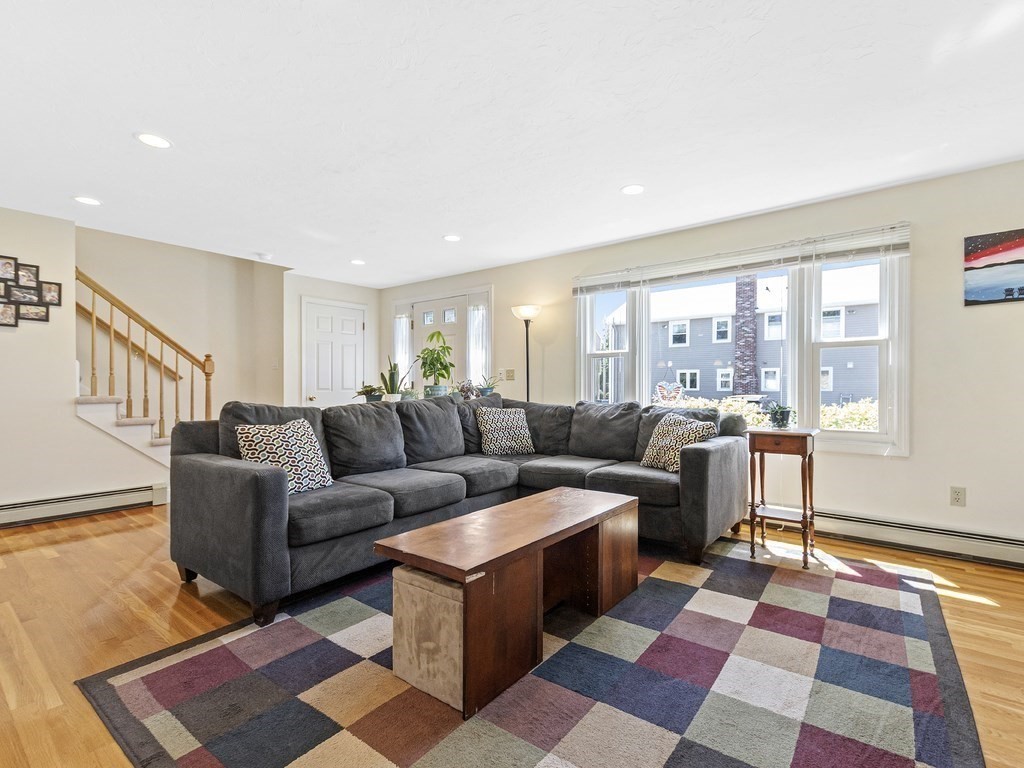 17 Central Street, Unit 2 Waltham, MA 02453 - Photo 11 of 39 a living room with a couch and a rug
