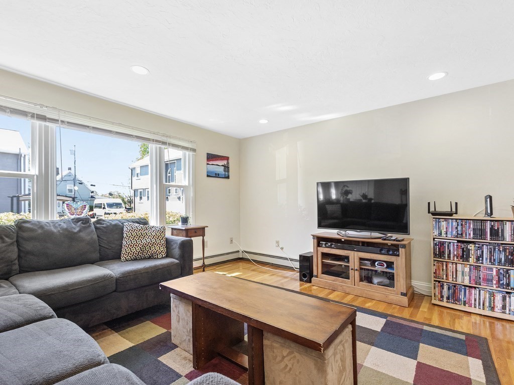 17 Central Street, Unit 2 Waltham, MA 02453 - Photo 13 of 39 a living room with furniture and a flat screen tv