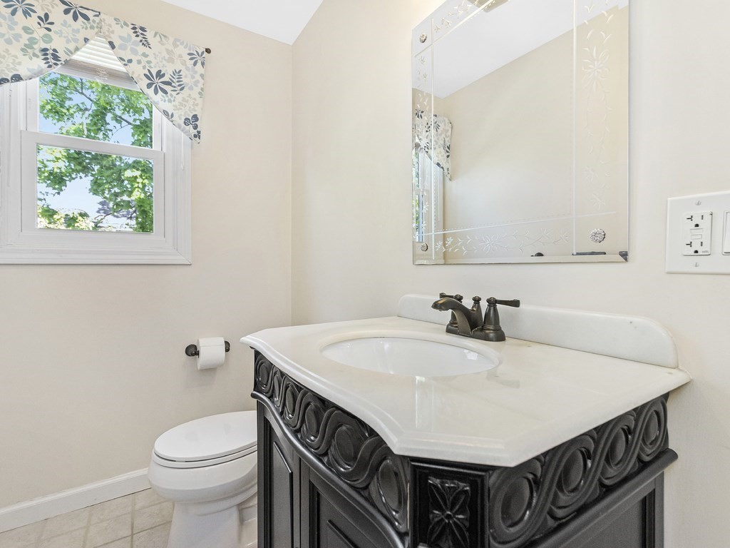 17 Central Street, Unit 2 Waltham, MA 02453 - Photo 20 of 39 a bathroom with a sink a toilet and a mirror