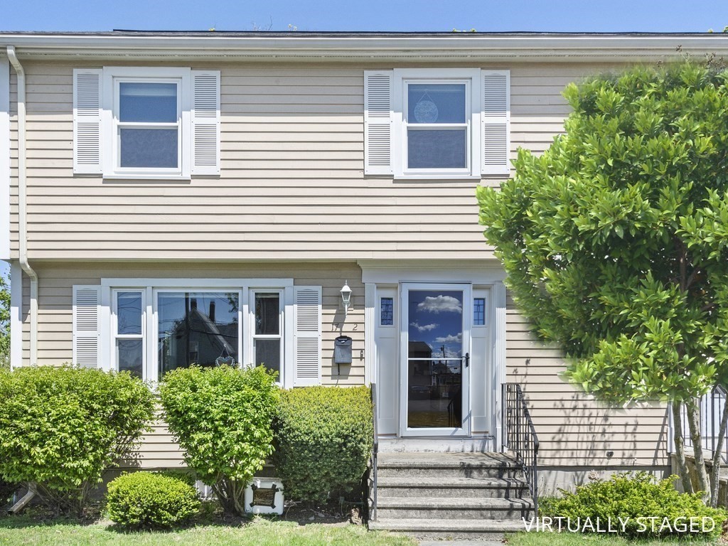 17 Central Street, Unit 2 Waltham, MA 02453 - Photo 2 of 39 a view of a brick house with plants and large tree