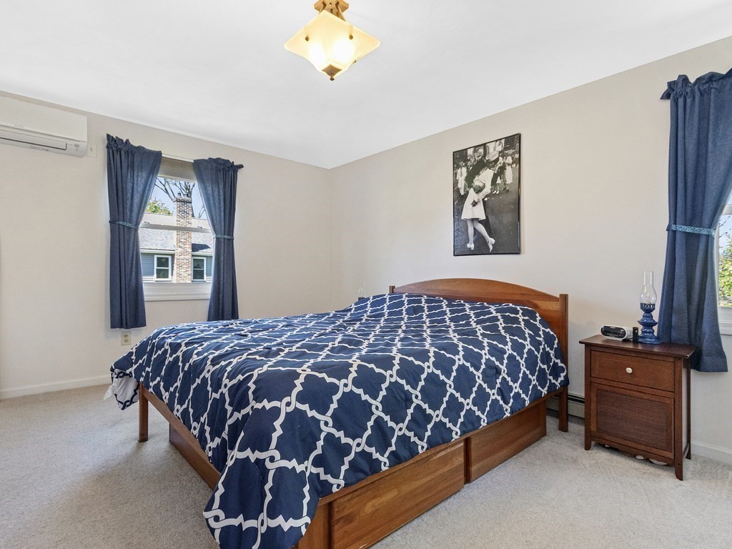 17 Central Street, Unit 2 Waltham, MA 02453 - Photo 21 of 39 a bedroom with a bed and a window