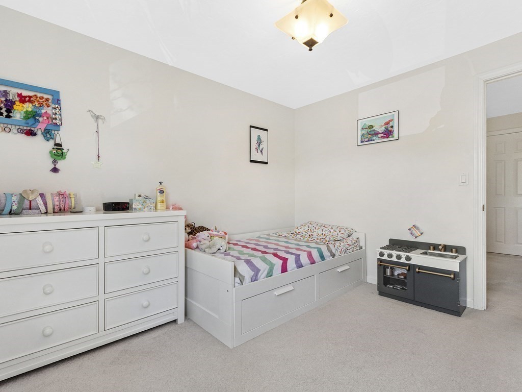17 Central Street, Unit 2 Waltham, MA 02453 - Photo 23 of 39 a bedroom with a bed and a cabinets