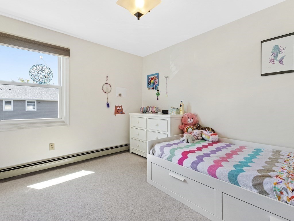 17 Central Street, Unit 2 Waltham, MA 02453 - Photo 24 of 39 a bedroom with baby bed and a dresser