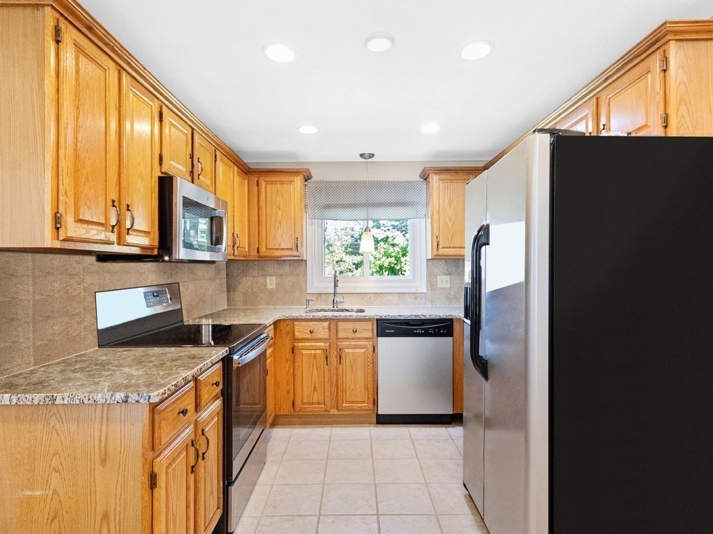 17 Central Street, Unit 2 Waltham, MA 02453 - Photo 3 of 39 a kitchen with stainless steel appliances granite countertop a refrigerator and a stove top oven
