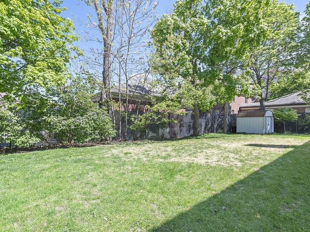 17 Central Street, Unit 2 Waltham, MA 02453 - Photo 33 of 39 a backyard of a house with trees and outdoor seating