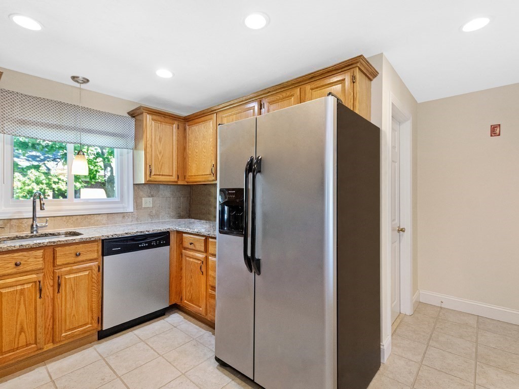 17 Central Street, Unit 2 Waltham, MA 02453 - Photo 7 of 39 a kitchen with stainless steel appliances granite countertop a refrigerator and a sink