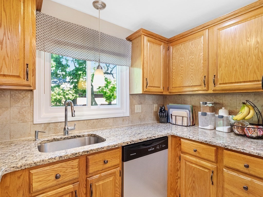 17 Central Street, Unit 2 Waltham, MA 02453 - Photo 8 of 39 a kitchen with granite countertop a sink a window and cabinets