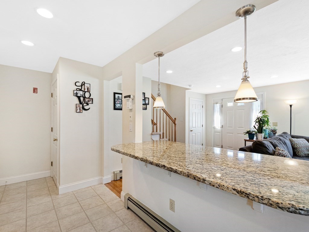 17 Central Street, Unit 2 Waltham, MA 02453 - Photo 9 of 39 a view of living room with granite countertop furniture and fireplace