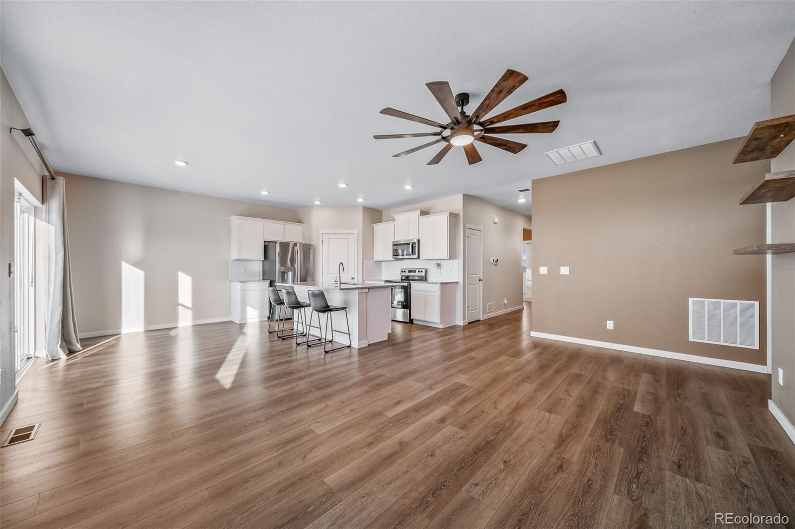 3018 Belleville Ridge Road Elizabeth, CO 80107 - Photo 11 of 32 a view of a livingroom with kitchen and wooden floor