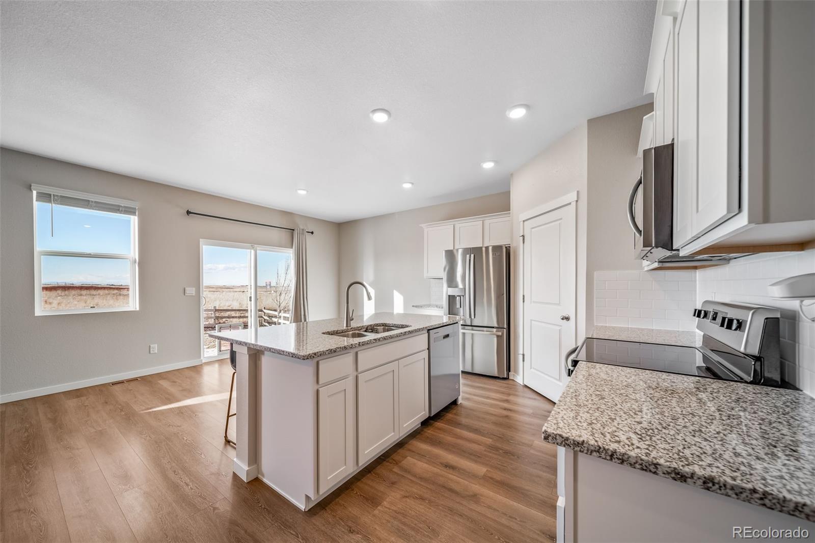 3018 Belleville Ridge Road Elizabeth, CO 80107 - Photo 14 of 32 a kitchen with stainless steel appliances granite countertop a sink stove and refrigerator