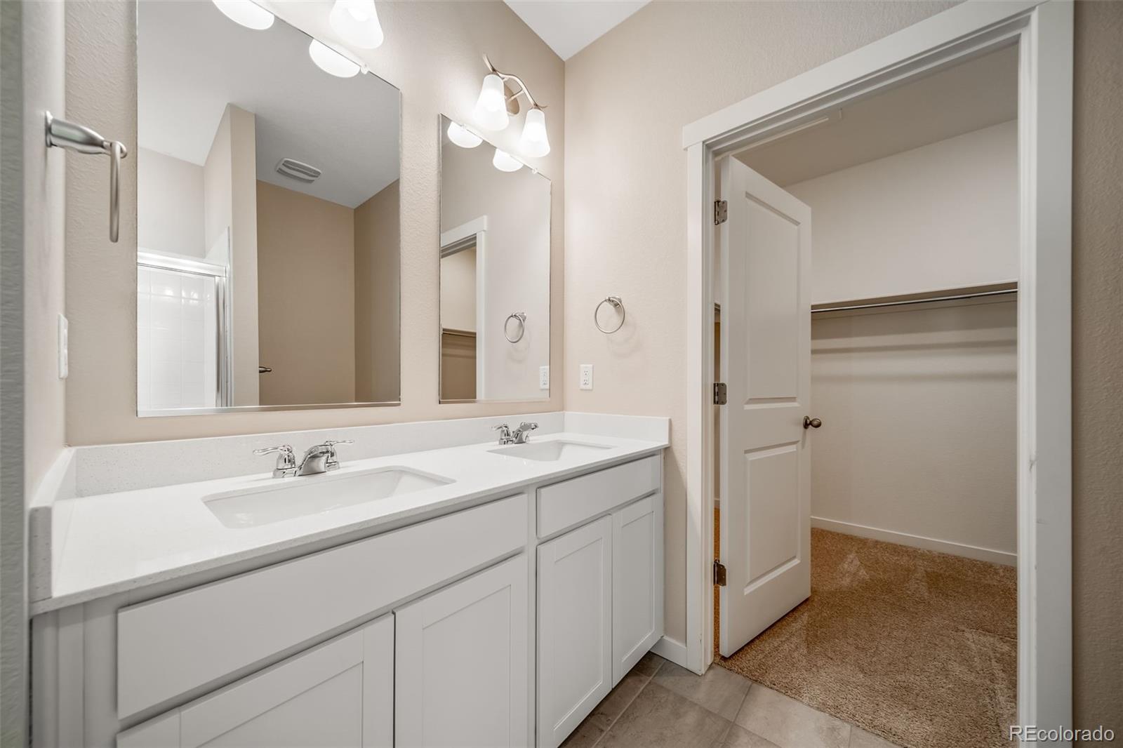3018 Belleville Ridge Road Elizabeth, CO 80107 - Photo 16 of 32 a bathroom with a sink and a mirror