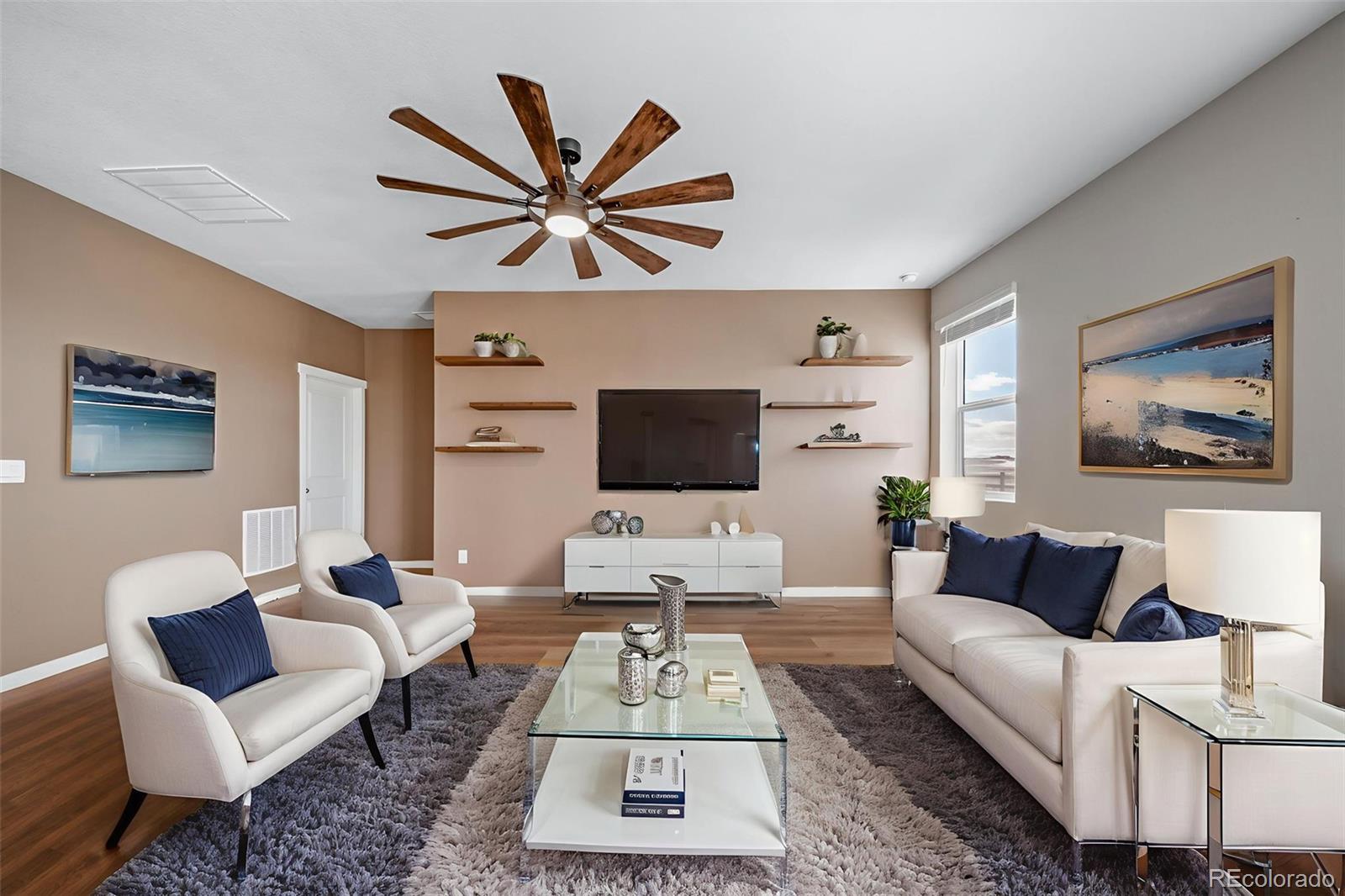 3018 Belleville Ridge Road Elizabeth, CO 80107 - Photo 9 of 32 a living room with furniture a rug and a flat screen tv