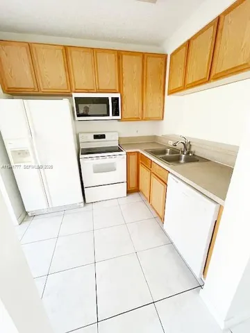 a kitchen with a stove a sink and a microwave