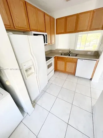 a kitchen with stainless steel appliances a refrigerator sink and cabinets