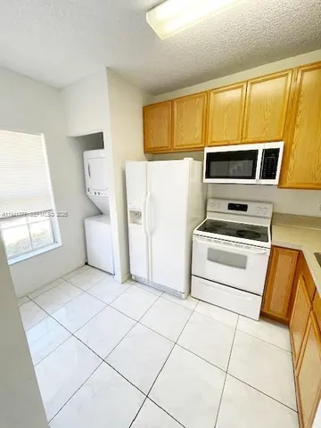 a kitchen with stainless steel appliances a stove a sink and a microwave