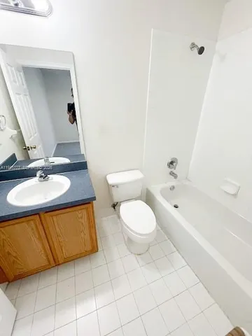 a white toilet sitting next to a shower